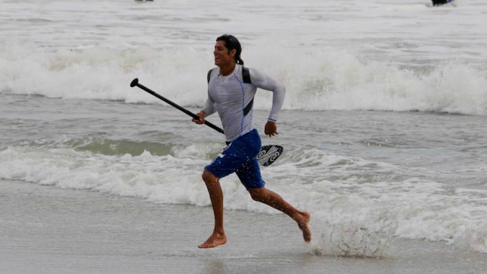 Fernando Stalla runs to the shore during a SUP practice session in Sayulita, Mexico